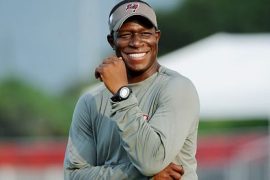 What team did Raheem Morris play for in the NFL? Was Raheem Morris a head coach?