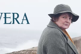 What is Vera’s accent? Why does Vera always wear a hat?