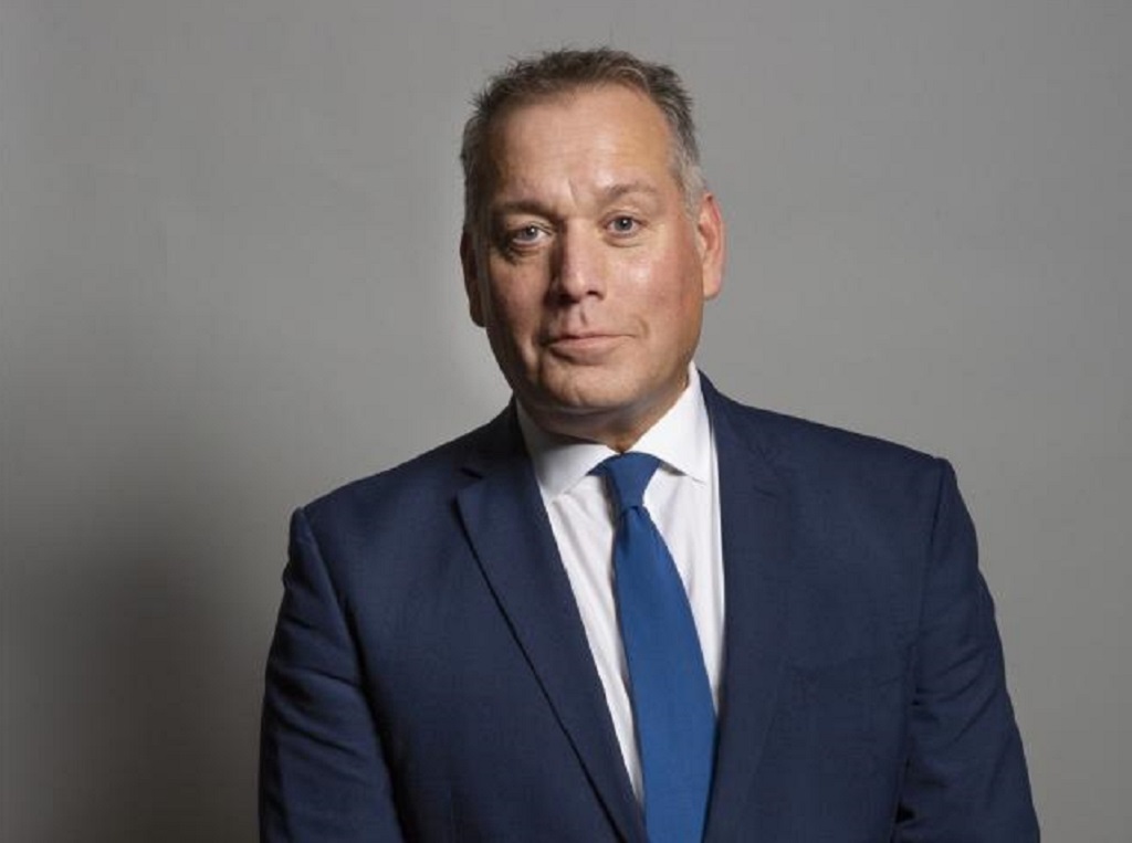 Why did David Warburton resign as MP?