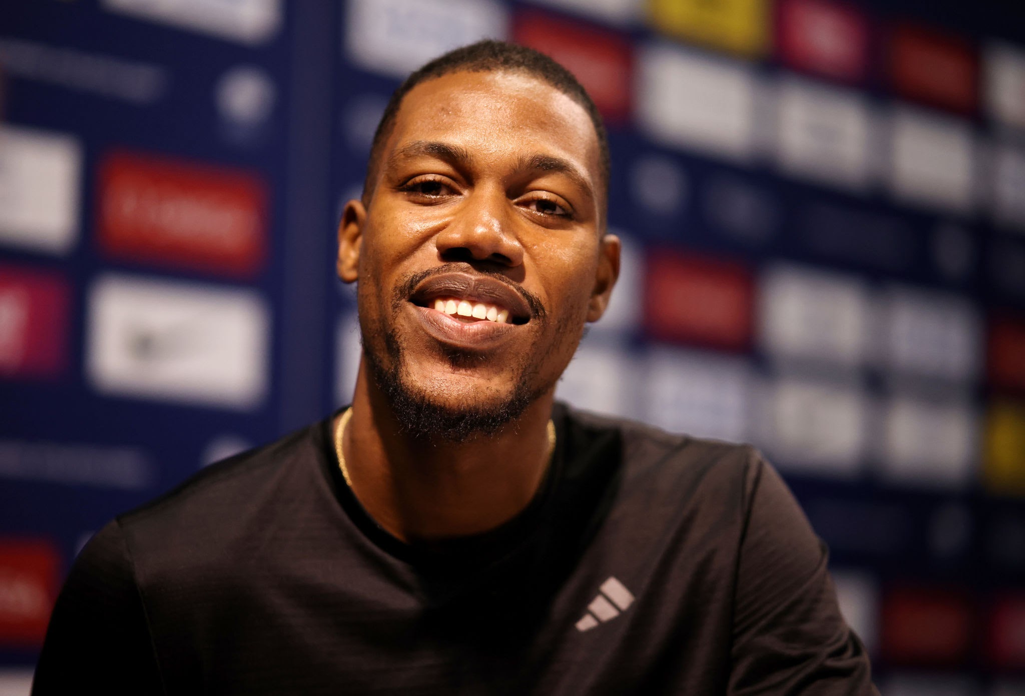 Why does Zharnel Hughes represent England? What is Zarnell Hughes British record?